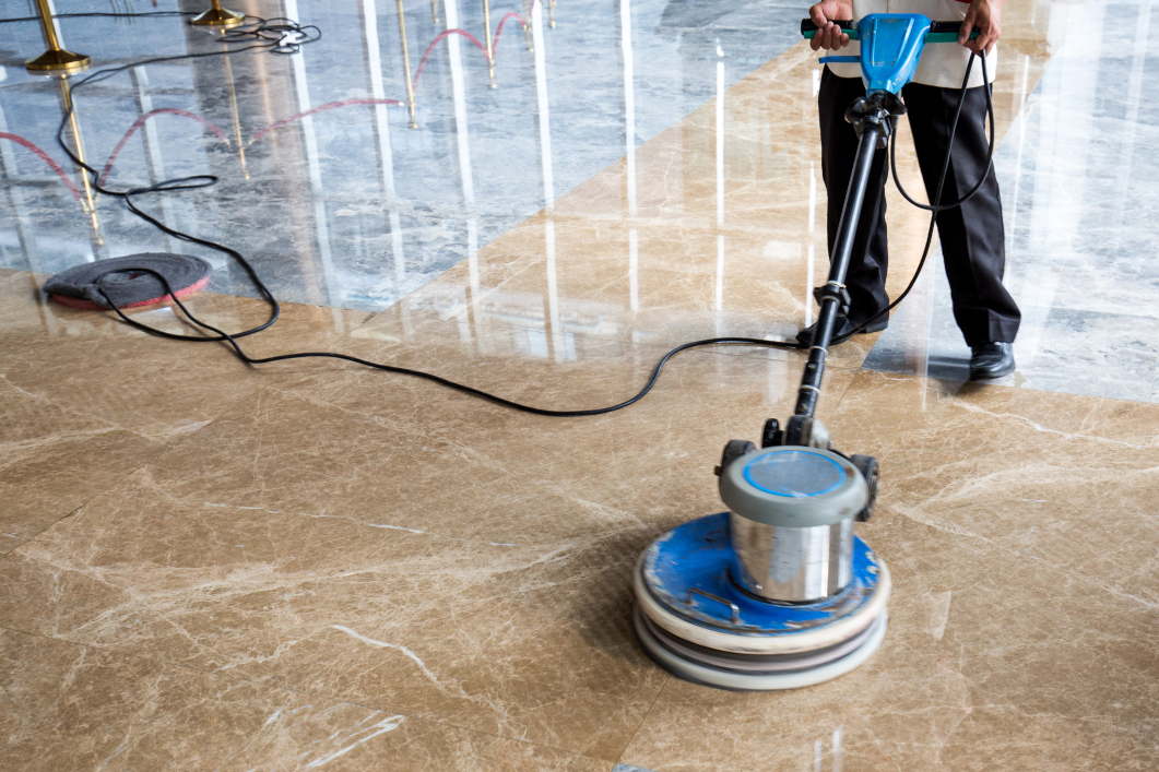 person polishing floor indoors